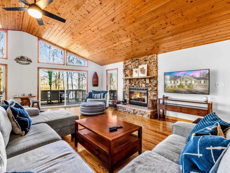 Cozy Lakeside Great Room – Relax in this spacious great room with vaulted wood ceilings, plush seating, and stunning views of Lake Anna. The stone fireplace adds rustic charm, but please note it is not available for guest use.