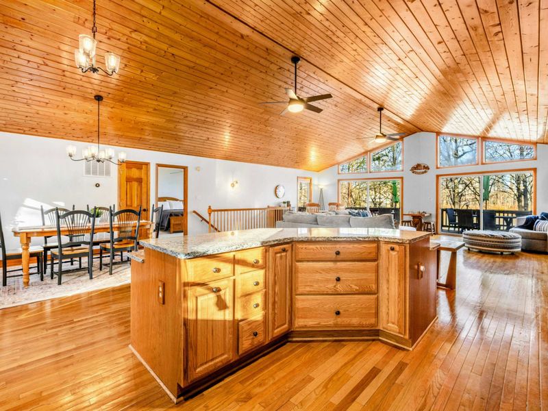 Spacious Kitchen and Living Area - Enjoy the expansive feel of this open-concept space, featuring a large kitchen island and extensive countertops that flow into a living area, ideal for entertaining and everyday living.