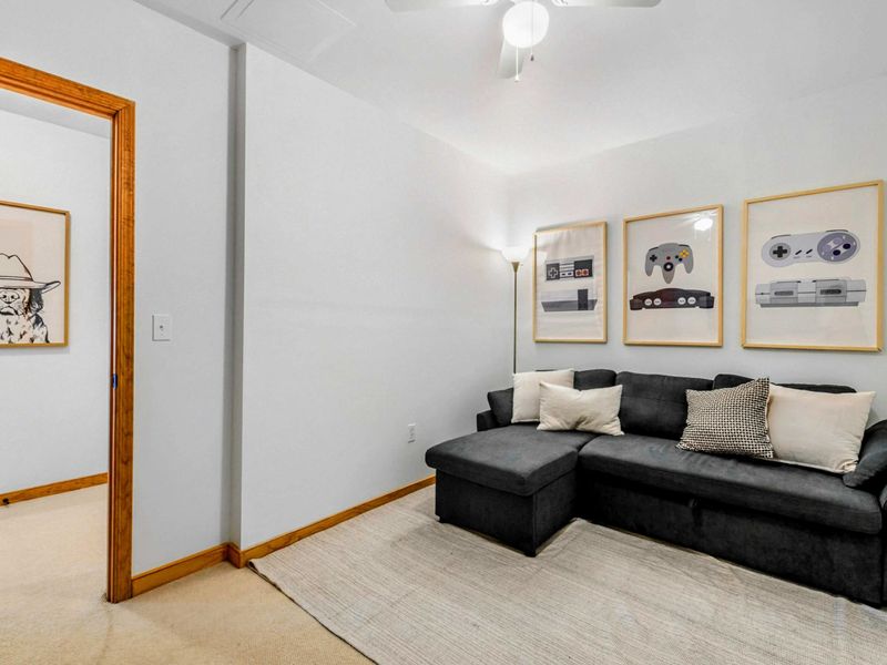 Cozy Gaming Nook – Tucked away for a bit of privacy, this comfy room features a soft sectional and fun gaming-themed artwork, making it a perfect little retreat for relaxing or playing video games.