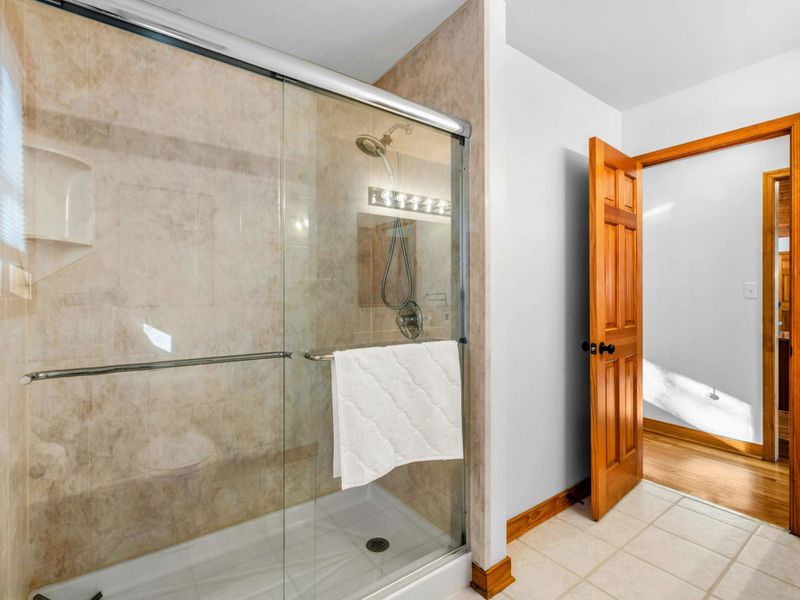 Bathroom 2 Tiled Walk-In Shower – Enjoy the ease of a tiled walk-in shower with glass doors and modern fixtures, conveniently located just steps from the adjacent bedroom.
