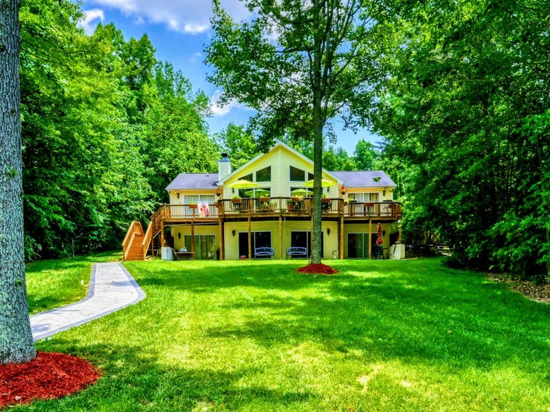 Lakefront Luxury at Lake Anna – Experience the ultimate retreat, surrounded by lush greenery and a large, verdant backyard leading to the lake. Featuring spacious decks and scenic views, it’s the perfect place for relaxation and outdoor enjoyment.