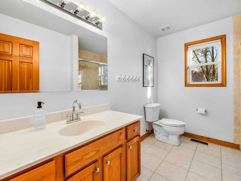 Spacious and Bright Bathroom 2 – This clean, welcoming bathroom features a large vanity, plenty of natural light, and thoughtful touches to make getting ready each day a pleasure.
