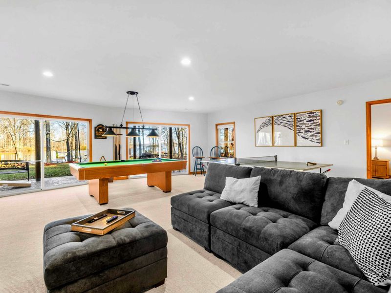 Relaxed Game Room – Enjoy leisure time in this spacious game room with a pool table and cozy lounge area. Bright and welcoming, it’s an excellent space for games or unwinding, surrounded by serene views of the outdoors.