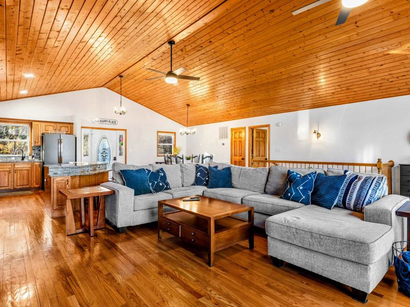 Great Room Gathering Space – Adorned with wooden ceilings and hardwood floors, this inviting great room features a large, comfortable seating area. Ideal for socializing or relaxing while enjoying panoramic views of Lake Anna.