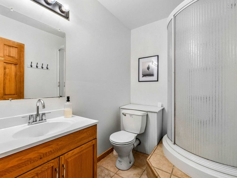 Lake Level Bath – This convenient full bath on the lake level features a step-in shower, modern vanity, and easy access for guests enjoying the game room and outdoor spaces.