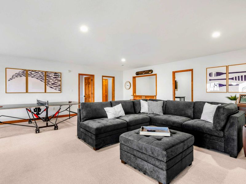 Relaxing Game Room Lounge – This plush sectional sofa anchors the game room, offering a cozy retreat for relaxation and conversation. The neutral decor and soft lighting create a welcoming space for family and guests to unwind.