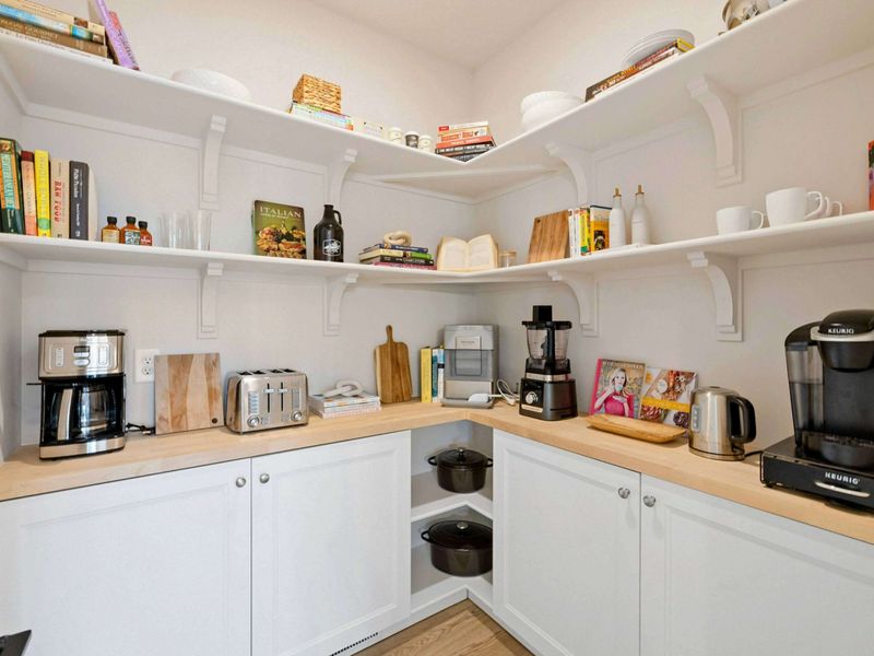 Everything in Its Place – The walk-in pantry is stocked and ready, with room for everyone’s favorites and your secret recipe stash.