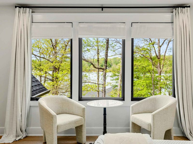 Bedroom 2 - Sitting nook with barrel chairs and a bistro table at the window, perfect for morning coffee with lake views.