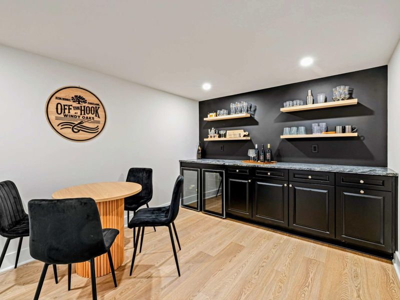 Thoughtfully Stocked, Effortlessly Cool – With floating shelves, dual beverage fridges, and a touch of drama, this bar is form and function combined.