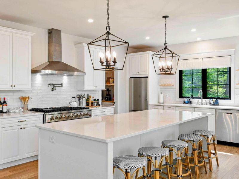 Center of the Home – Anchored by a massive island and open layout, this kitchen blends function with flow.