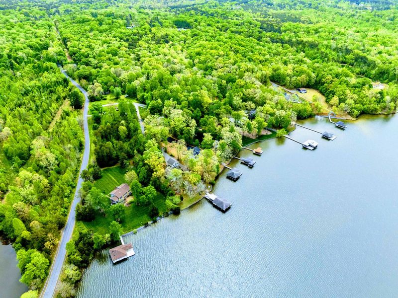 Aerial - Windy Oaks Road and the lakefront lots with private docks lining the shoreline.