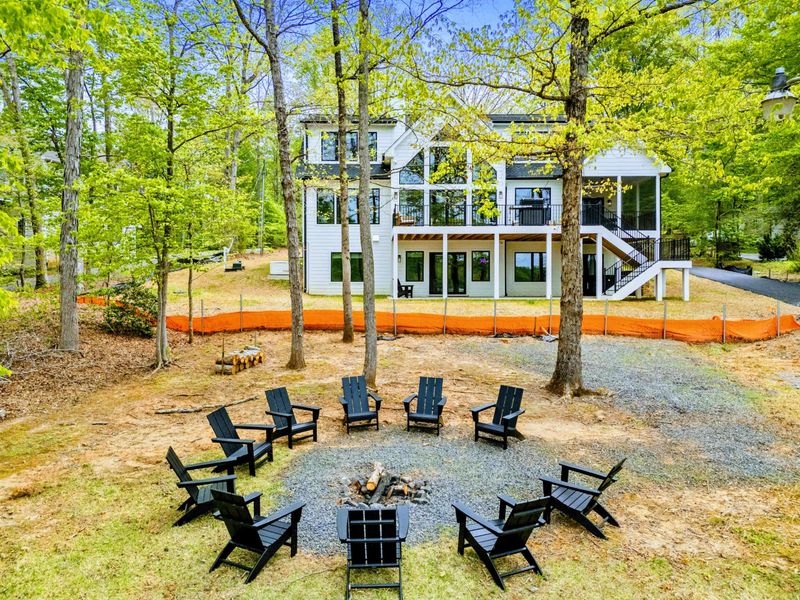 Home in the Background, Heart at the Center – Let the flames draw you in while the house lights glow behind you.