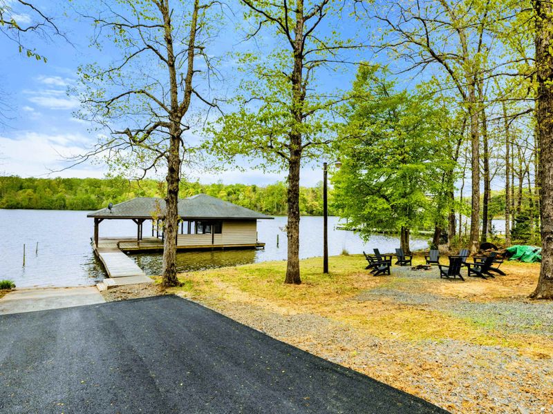 Seamless Serenity – A private launch, shaded gathering space, and still water beyond—welcome to the heart of the property.