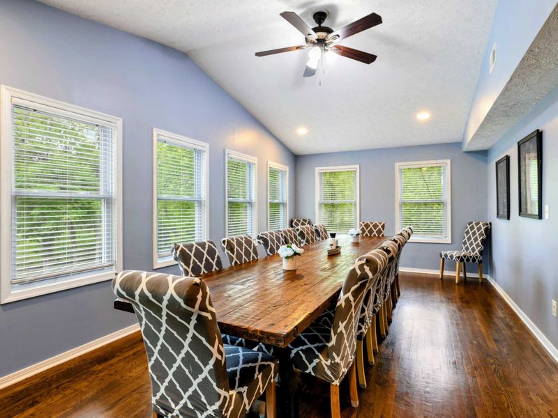 Let the Conversations Flow – Surrounded by windows and filled with light, this room makes every meal special.