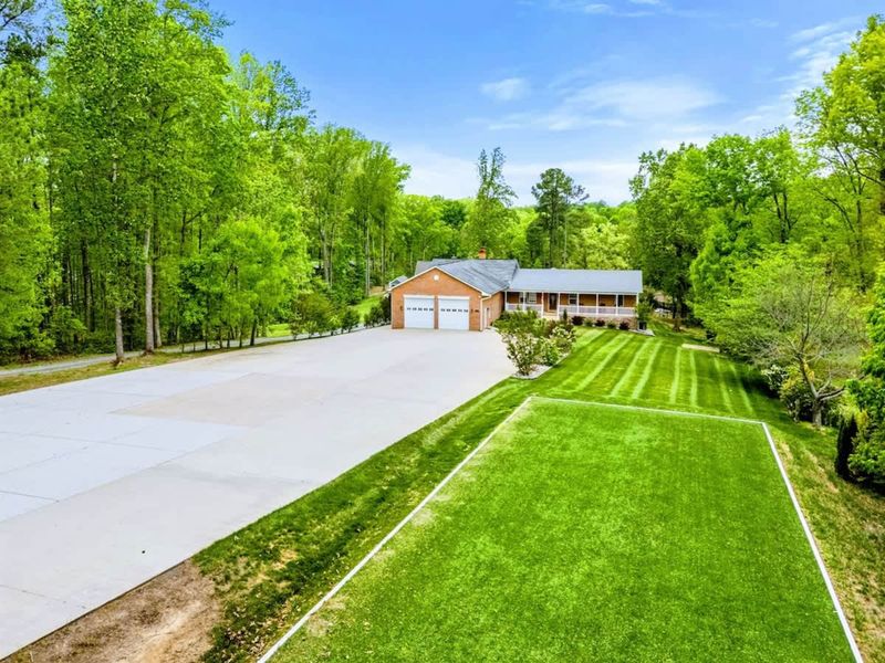 Room to Arrive, Room to Play – The driveway, garage, and field combine ease with energy.