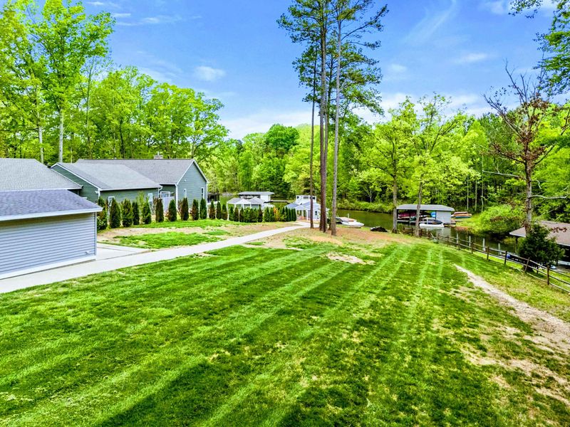 From Grass to Glassy Water – Whether you’re barefoot in the yard or heading down to the dock, the outdoors flows freely here.