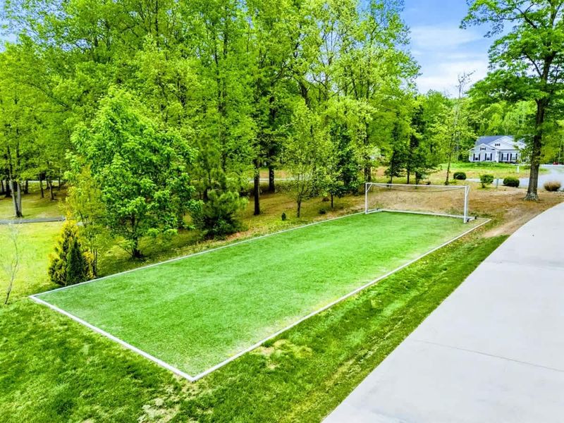 Kick Back, Literally – A lush green field just steps from the house, made for fun and friendly competition.