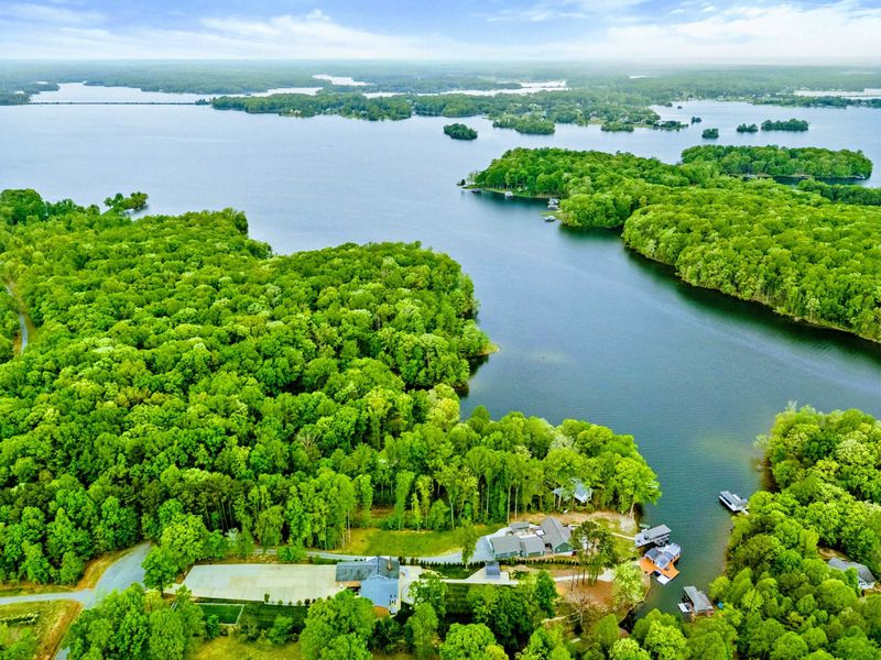 Aerial - High-altitude panoramic view of the forested Lake Anna shoreline with islands, coves, and docks.