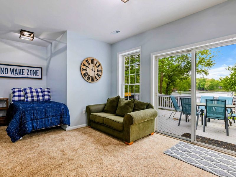 Another Place to Gather – With lake views and room to relax, this lower-level living space brings everyone together.