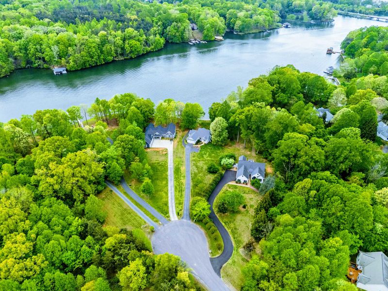 Tucked Away, Right by the Water – This cul-de-sac retreat offers wooded privacy with the lake just steps from your door.