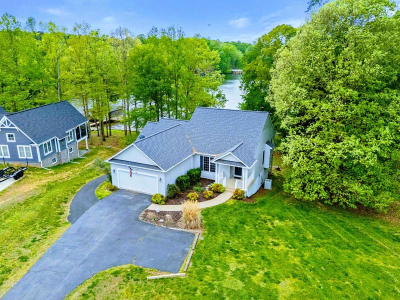 Tucked in, Yet Wide Open – Nestled in the trees with the lake just down the path, this home offers space, serenity, and togetherness.