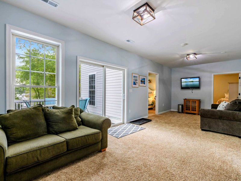 Spread Out Without Splitting Up – With space for lounging, movies, and quiet time, this lower-level living room keeps everyone close.