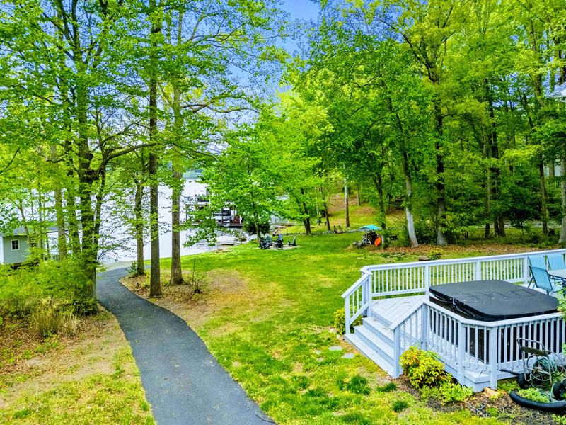 The Backyard that Keeps Giving – Deck chats, lakeside laughter, and an easy stroll between it all.