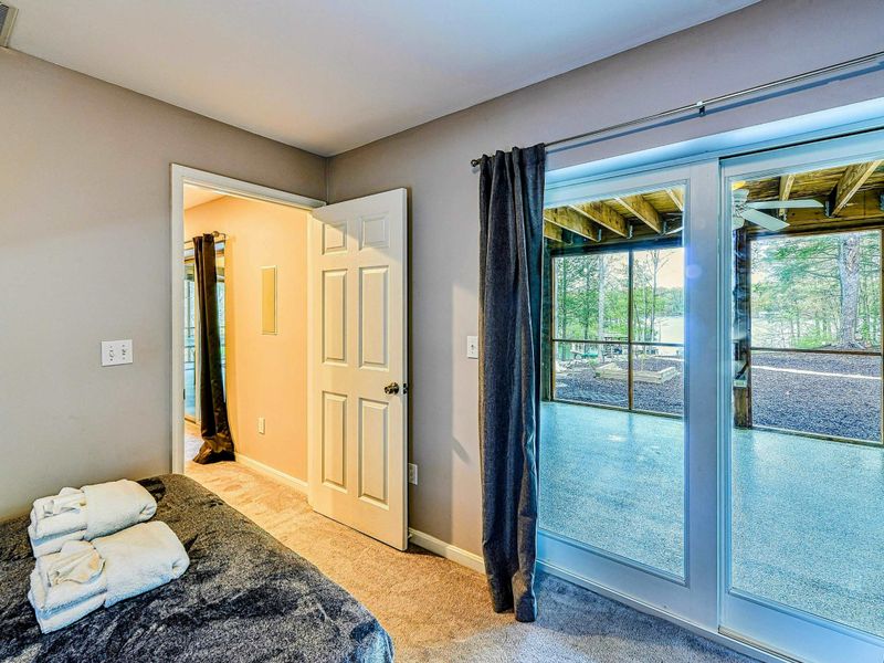 Bunk Room - Sliding glass doors to the screened porch and yard with en suite bathroom entry.