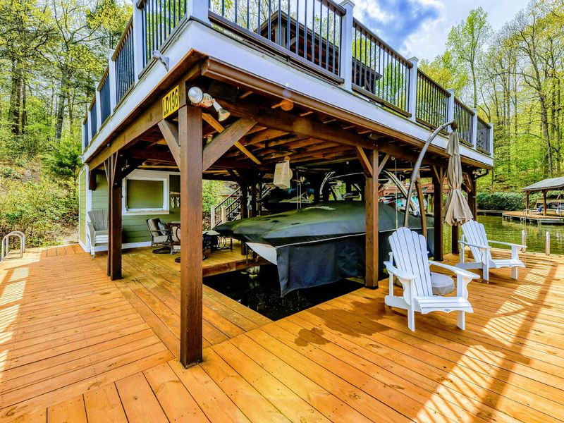 Lower Dock - Covered boat lift with Adirondack chairs and the upper sundeck gazebo above.