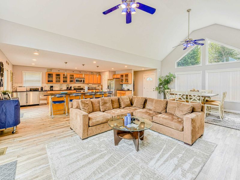 Living Room - Open floor plan from the kitchen island through the living area with vaulted ceilings throughout.