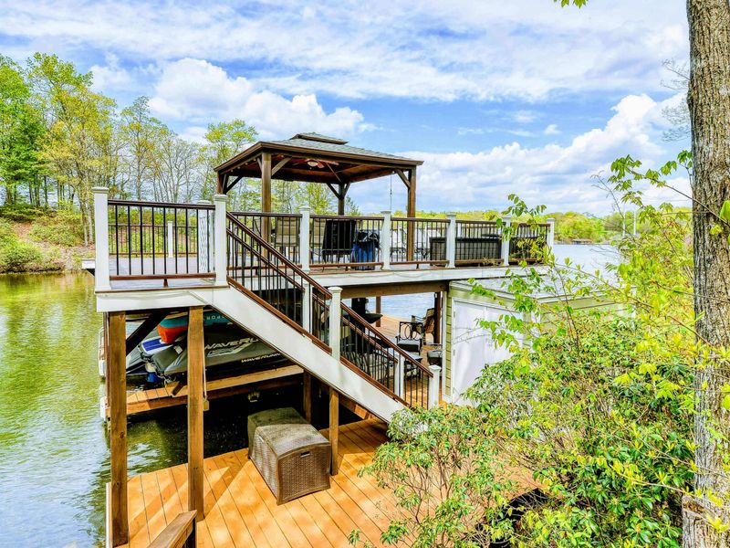 Dock - Full view of the two-level dock with stairs, gazebo, and metal railings from the hillside.