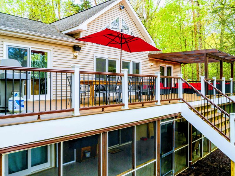 Exterior - Side view showing the upper deck, A-frame windows, and stairway to the lower level.