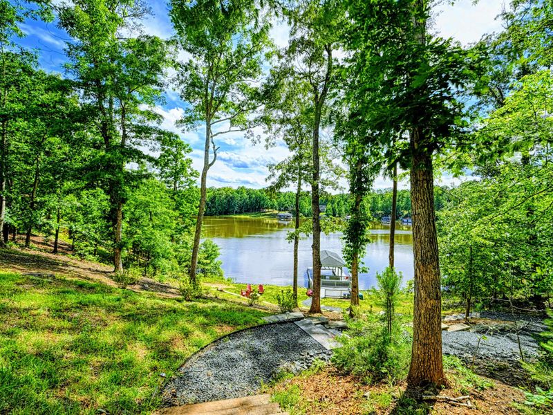 Walkway - Paved path through the trees leading down to the dock and lake from the home.