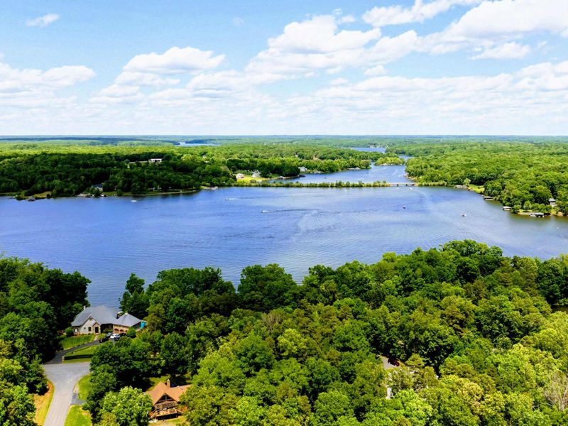 Aerial - Expansive Lake Anna view showing the wide waterway, wooded peninsula, and surrounding countryside.