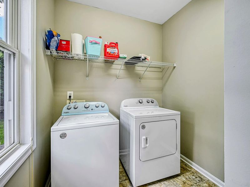 Laundry Room - Full-size washer and dryer with wire shelf and window on the main level.