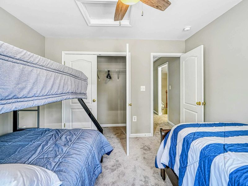 Bedroom 5 - Alternate showing the bunk bed, closet, en suite bathroom doorway, and skylight above.