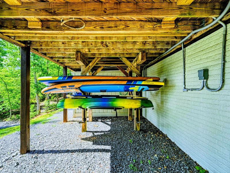 Kayak Storage - Alternate view of the paddleboard and kayak rack with the walkway to the dock beyond.