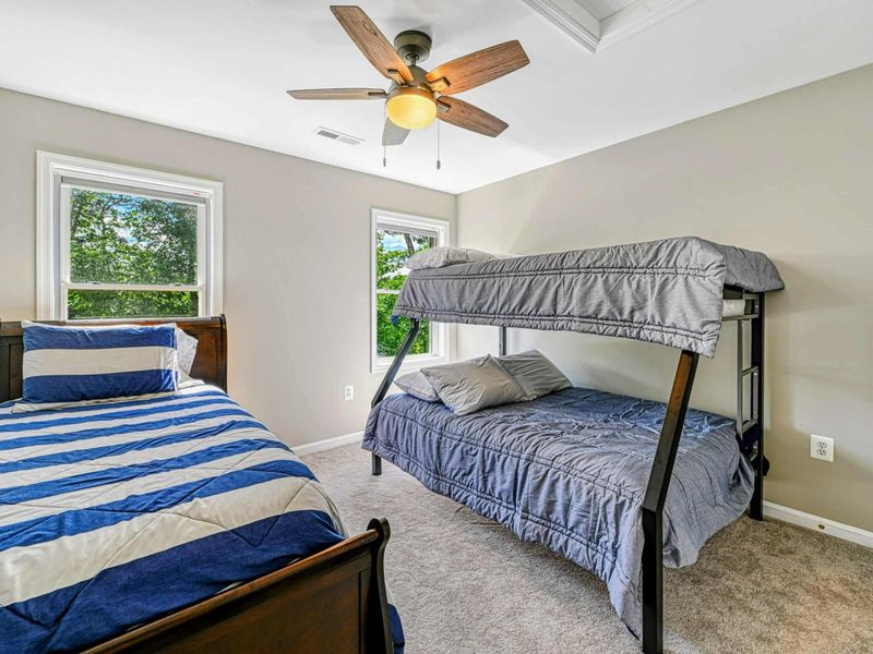 Bedroom 5 - Twin-over-full bunk bed with twin sleigh bed, blue-striped bedding, ceiling fan, and skylight on the upper level.