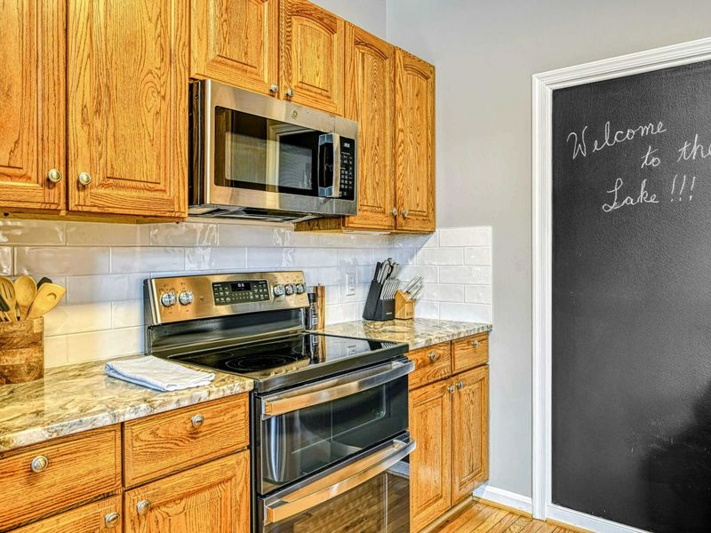 Kitchen - Range and chalkboard wall detail with the subway tile backsplash and oak cabinetry.