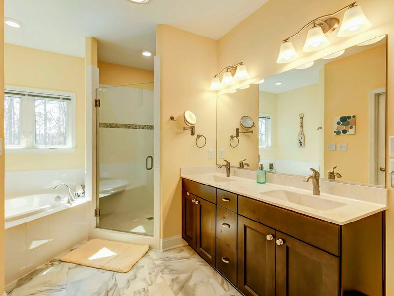 Your Private Spa Retreat – A deep soaking tub, dual sinks, and a walk-in shower make this space feel like vacation every day.