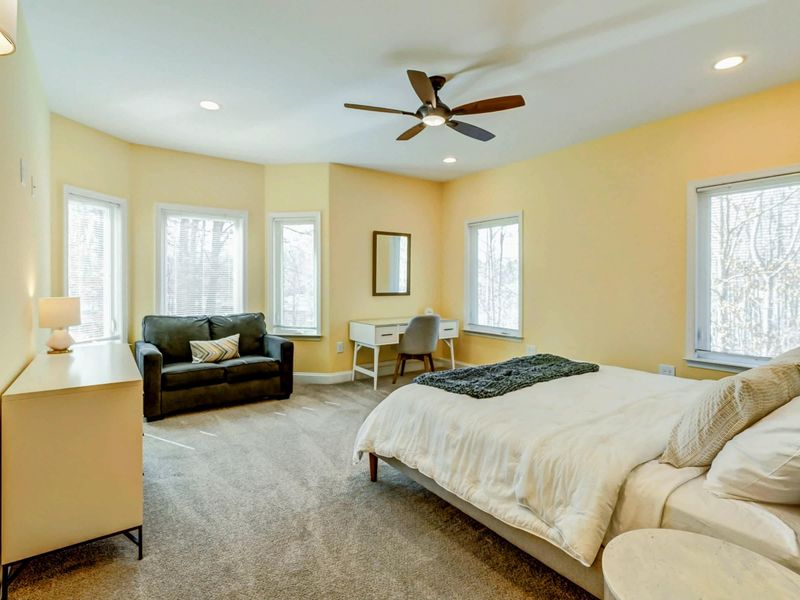Rest Comes Easy Here – Plush bedding, peaceful views, and a sitting area that makes this room feel like its own private hideaway.