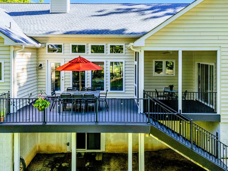Sun or Shade, You Decide – With a screened porch on one side and open-air dining on the other, this outdoor space suits every mood.