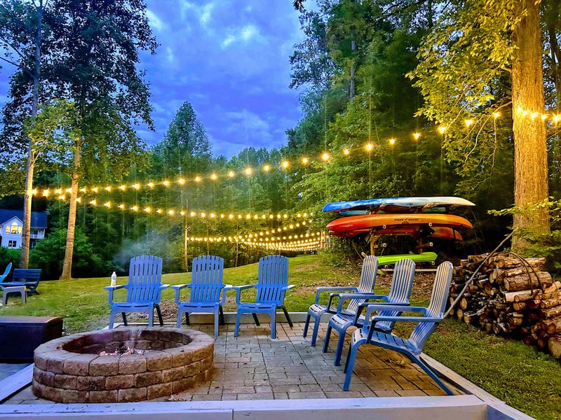 Where the Night Comes to Life – Firelight, string lights, and laughter under the trees—this is lakeside evening perfection.