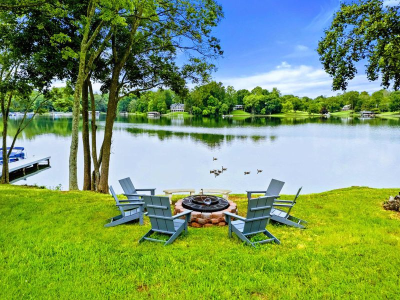 Fire Pit - Adirondack chairs circle the fire pit on the waterfront lawn, a natural gathering spot as the sun goes down.