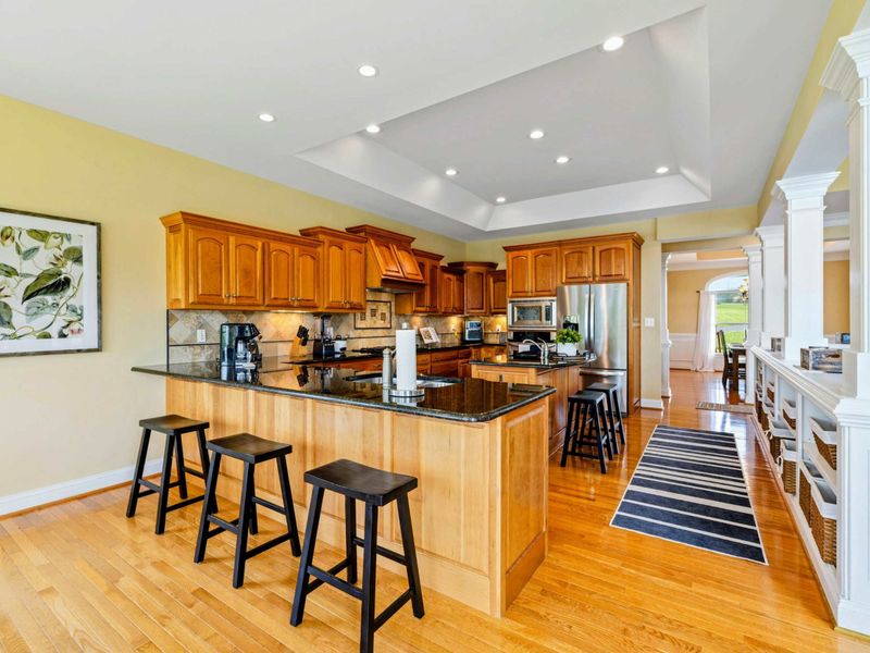 Kitchen Bar Seating - Three stools at the granite island offer a casual spot for quick meals or keeping the cook company.