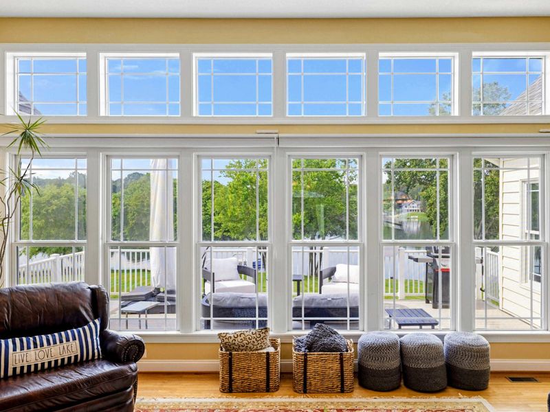 Window Wall - Floor-to-ceiling windows with transom glass look out to the deck and the lake, blurring the line between indoors and out.