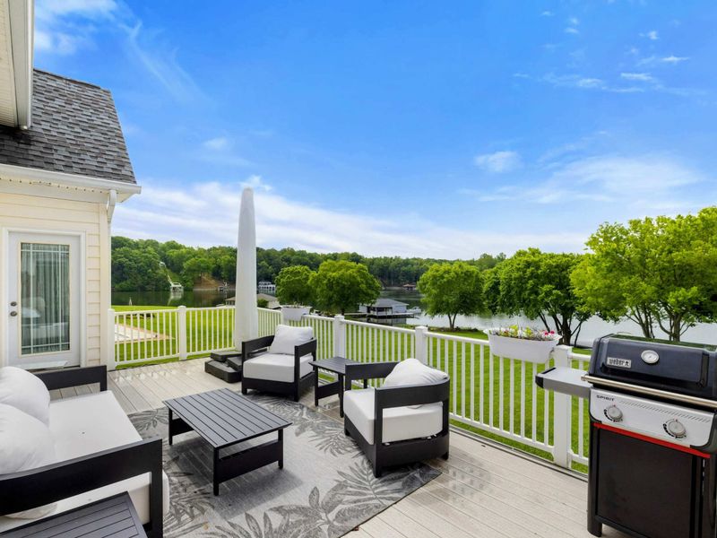 Deck with Lake Views - Lounge seating, a grill, and an unobstructed sightline to the water from the upper deck.