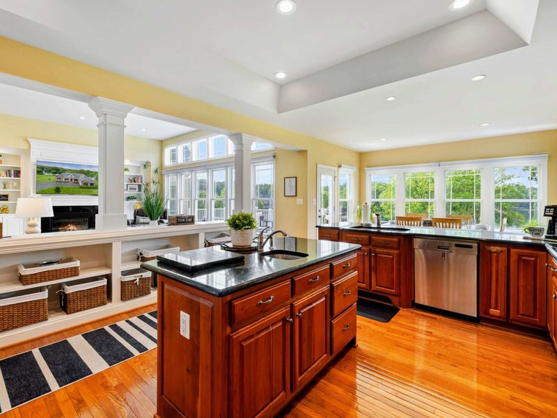 Kitchen and Living - The open kitchen overlooks the great room through the columned half-wall, keeping everyone connected.