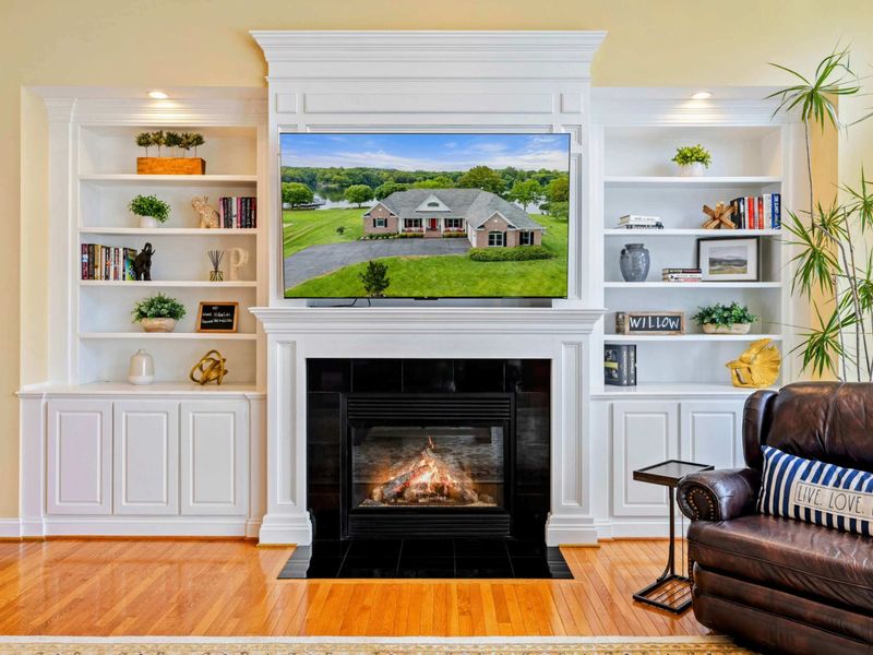 Fireplace Detail - The custom built-in mantel, Smart TV, and curated bookshelves create a polished focal point in the great room.