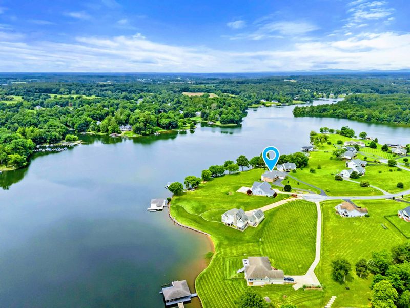 Waterfront Position - From the lake side, the full 220 feet of deep-water shoreline and private dock come into view.